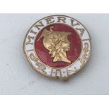 A Minerva part enamel lapel badge.