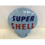 A blue Super Shell glass petrol pump globe by Hailware, with chipping to neck, also with bright