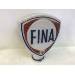 A Fina glass petrol pump globe with slight fading.