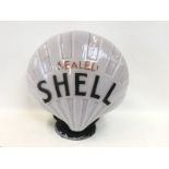 An early Sealed Shell glass petrol pump globe with repaired patch to one side.