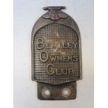 A car badge shaped as a Bentley radiator.