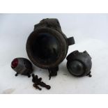 A set of three aluminium gas lamps for an early motorcycle, the headlamp with star motif and the