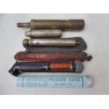 A selection of tyre pressure gauges plus an oil/grease gun.