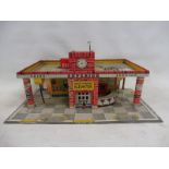 A Mettoy tinplate model garage.