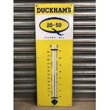 A Duckham's 20-50 Motor Oil enamel thermometer, in good condition, 13 x 36".