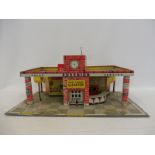 A Mettoy tinplate model garage.