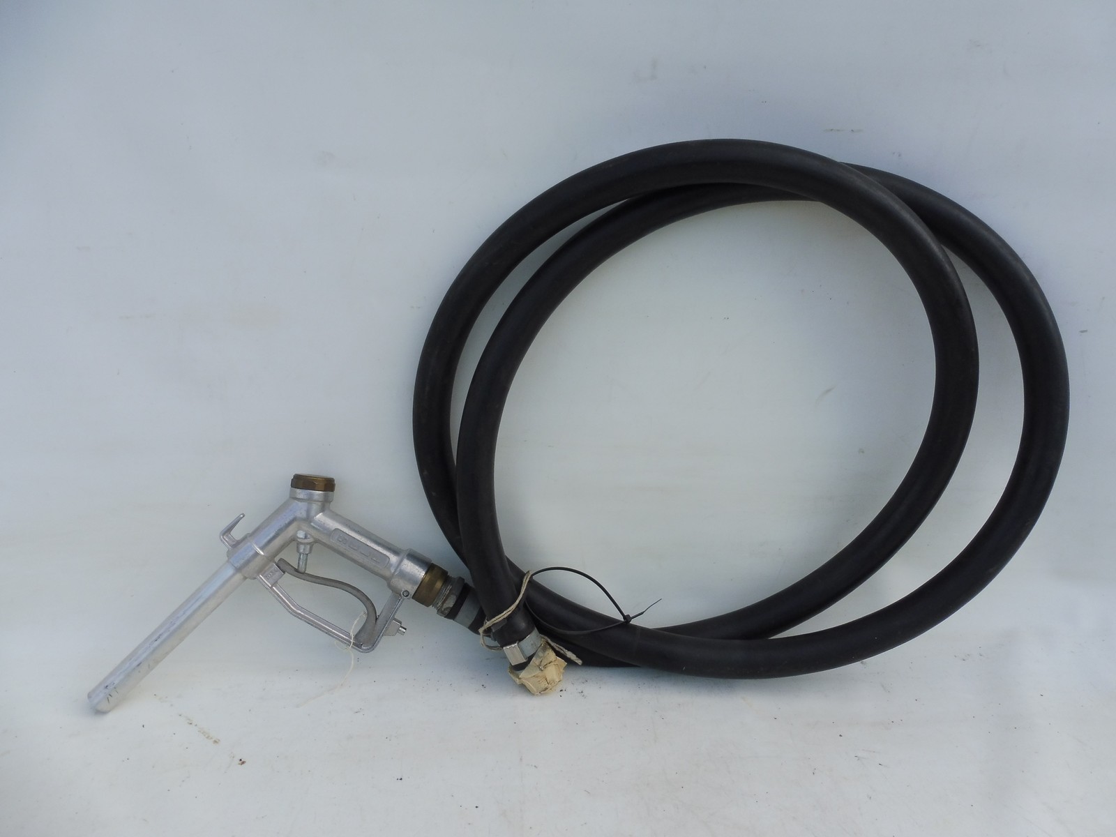 A petrol pump nozzle and hose.