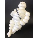 A Michelin Mr. Bibendum air pump figure with folding bracket underneath.