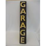 A narrow rectangular 'Garage' sign formed by metal letters on a wooden board, 7 1/2 x 48".