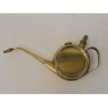 A good quality polished brass oiler of circular form.