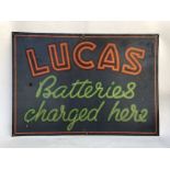 A 'Lucas Batteries Charged Here' rectangular tin advertising sign, 27 x 19".