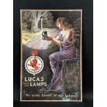 A decorative Lucas Lamps pictorial advertisement depicting a scantily clad lady holding a lamp,