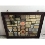 A framed display of various car rally plaques, many from the late 1960s and early 1970s, mostly