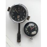 A Smiths 2" black faced eight day car clock with long winding stem plus a Smiths watch with brightly