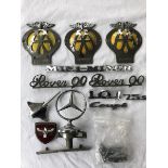 A quantity of badges and insignia to include Mini Minor, Rover 90 and a Mercedes three star mascot.