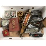 A box of assorted motorcycle insignia, Carburol dispensing gun etc.