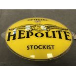 An oval Hepolite Official Stockist sign in perspex.