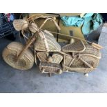 A well made model motorcycle crafted out of wicker.