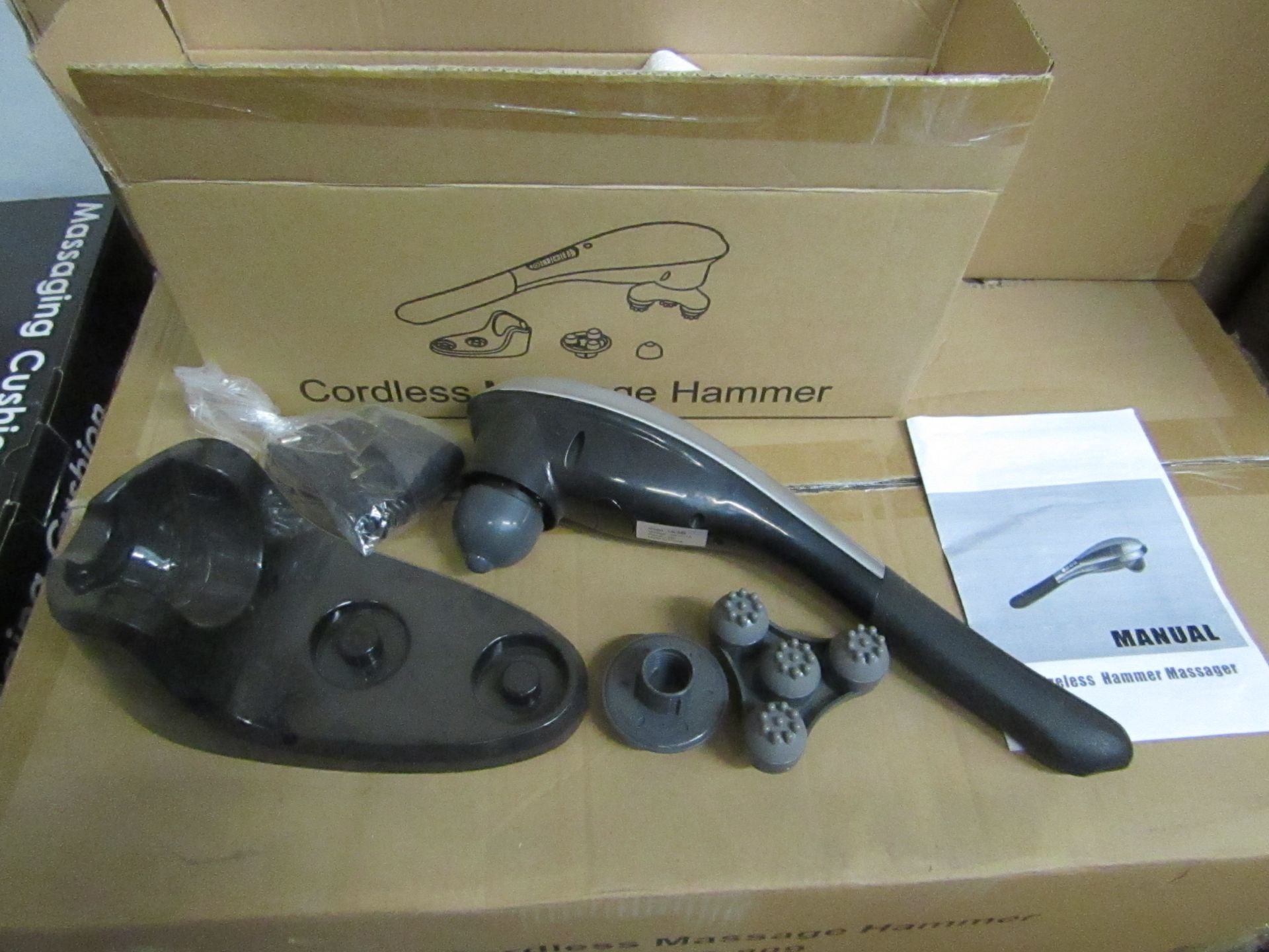 Cordless handheld massage hammer with various head attachments. New & boxed.