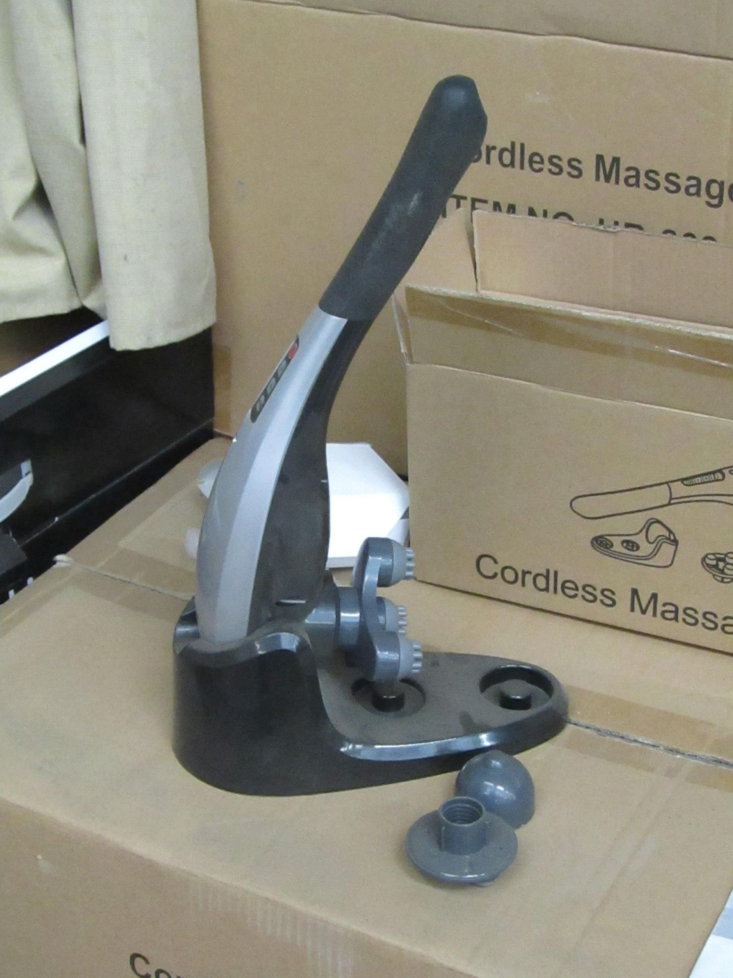 Cordless handheld massage hammer with various head attachments. New & boxed.