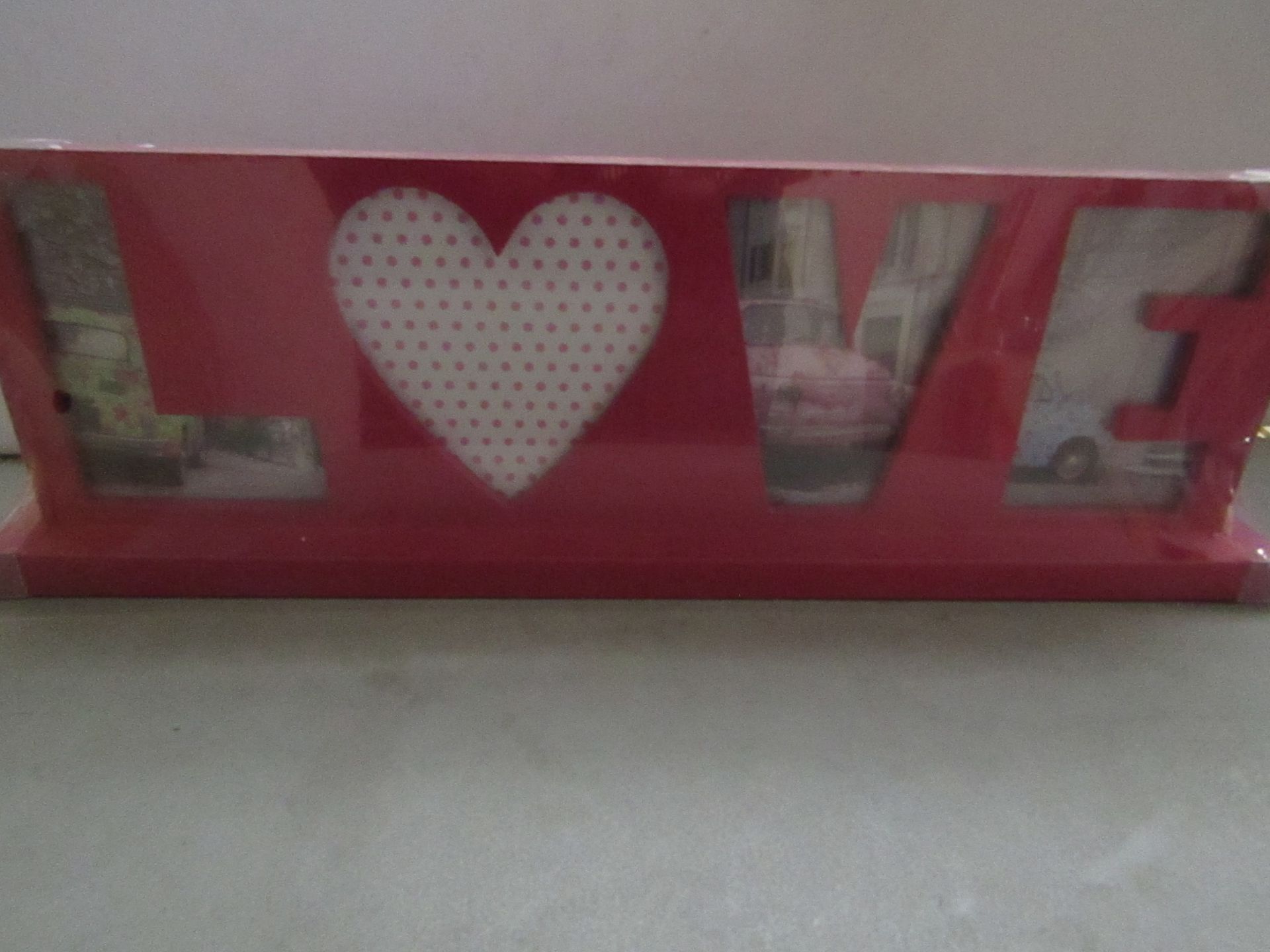 5 x love themed photo frames , new and packaged.