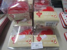 20 packs of heart shaped lights with 8 in a pack , packaged.