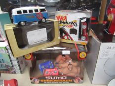 3 x items being a remote controlled wall climbing car , RC campervan and a Sumo smackdown remote