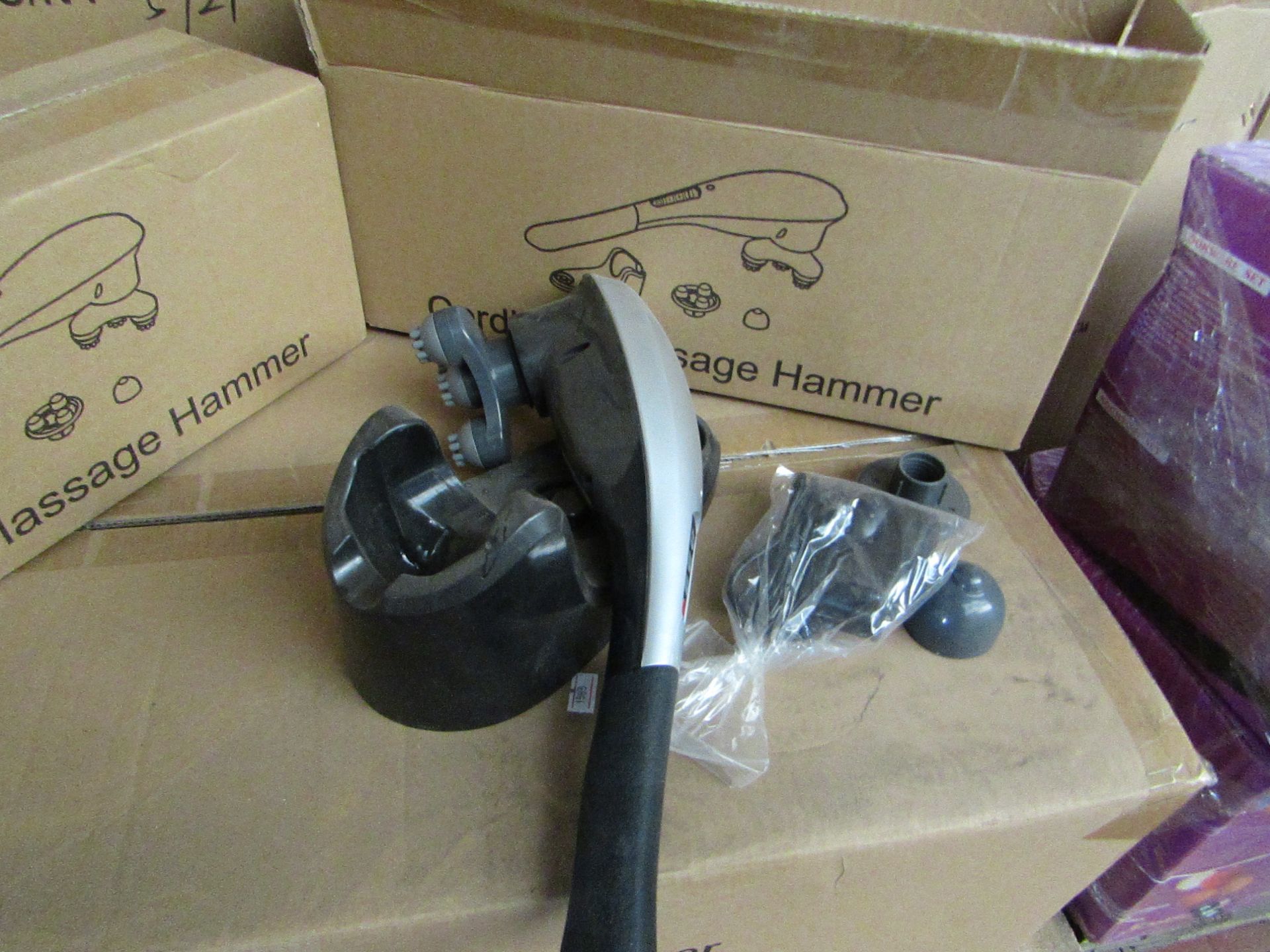 Cordless handheld massage hammer with various head attachments. New & boxed