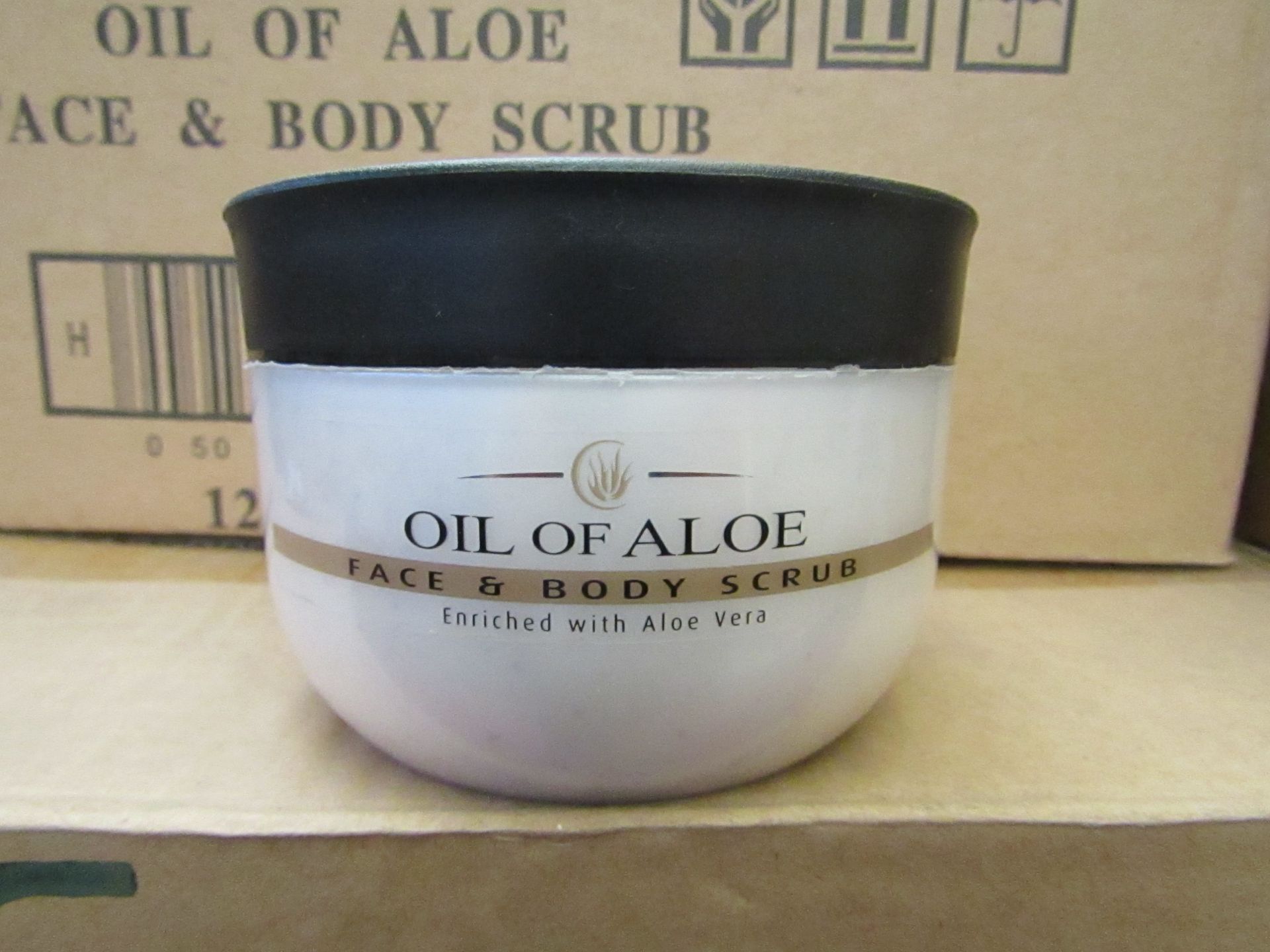 12 x 300ml Oil Of Aloe face and body scrub, unused and boxed.
