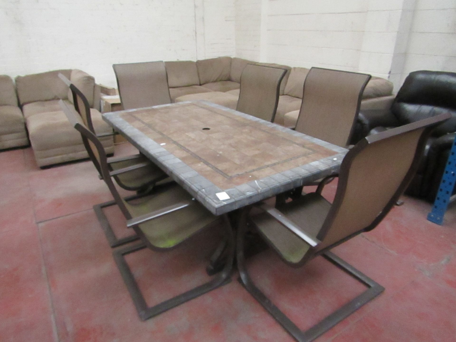 6 Seater Tile topped table and 6 Chairs, one of the chairs is damaged and one of the corners of