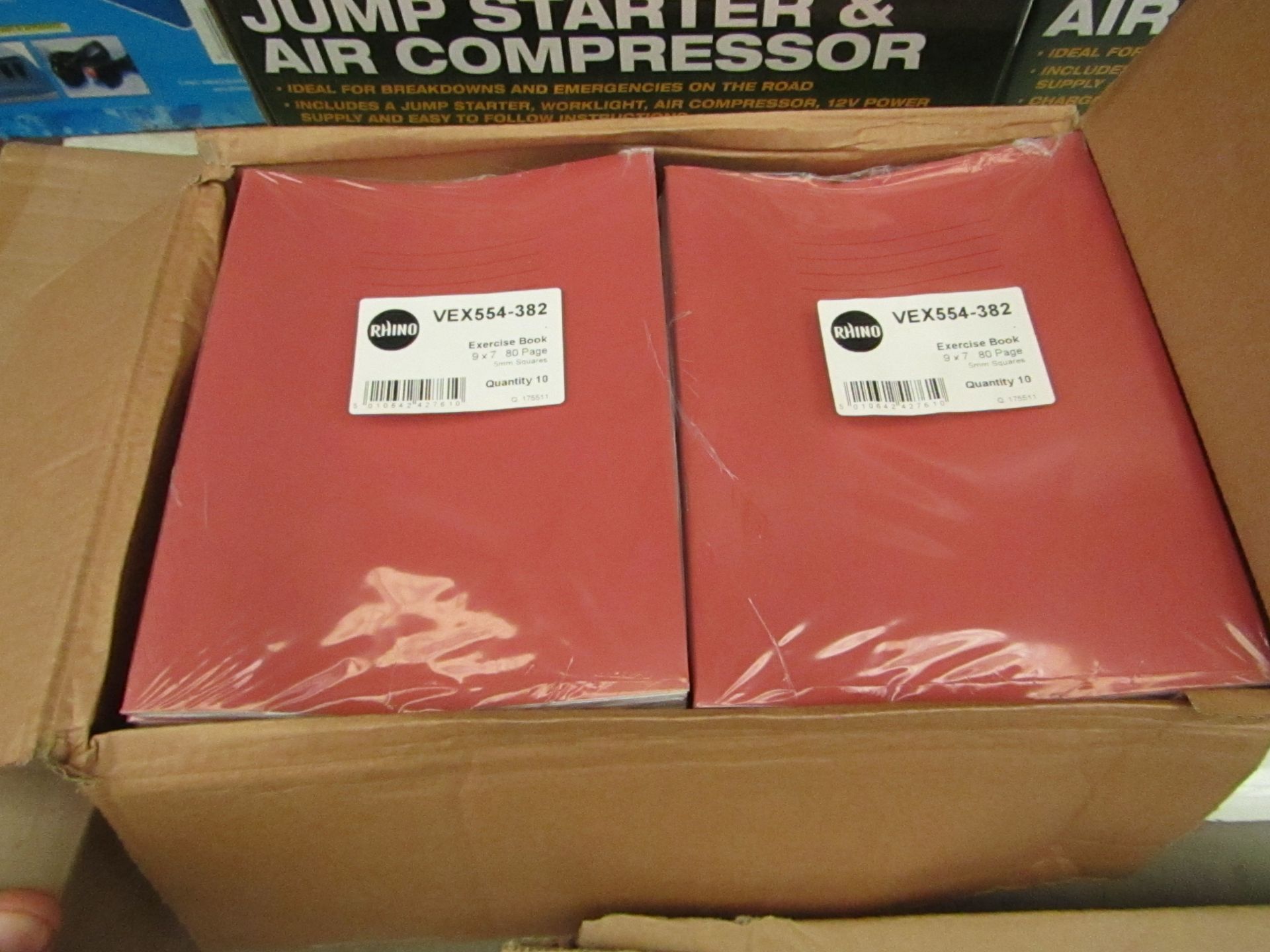 100x Red coloured exercise books, all new and boxed.