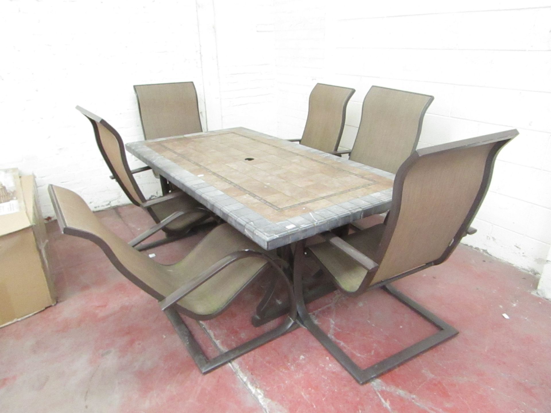 6 Seater Tile topped table and 6 Chairs, one of the chairs is damaged and one of the corners of