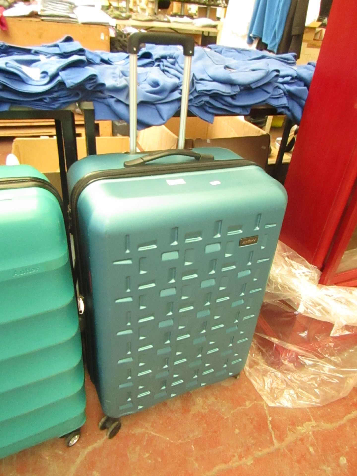 Large metalic blue suitcase on wheels with pull out handle,few scuffs but nothing major