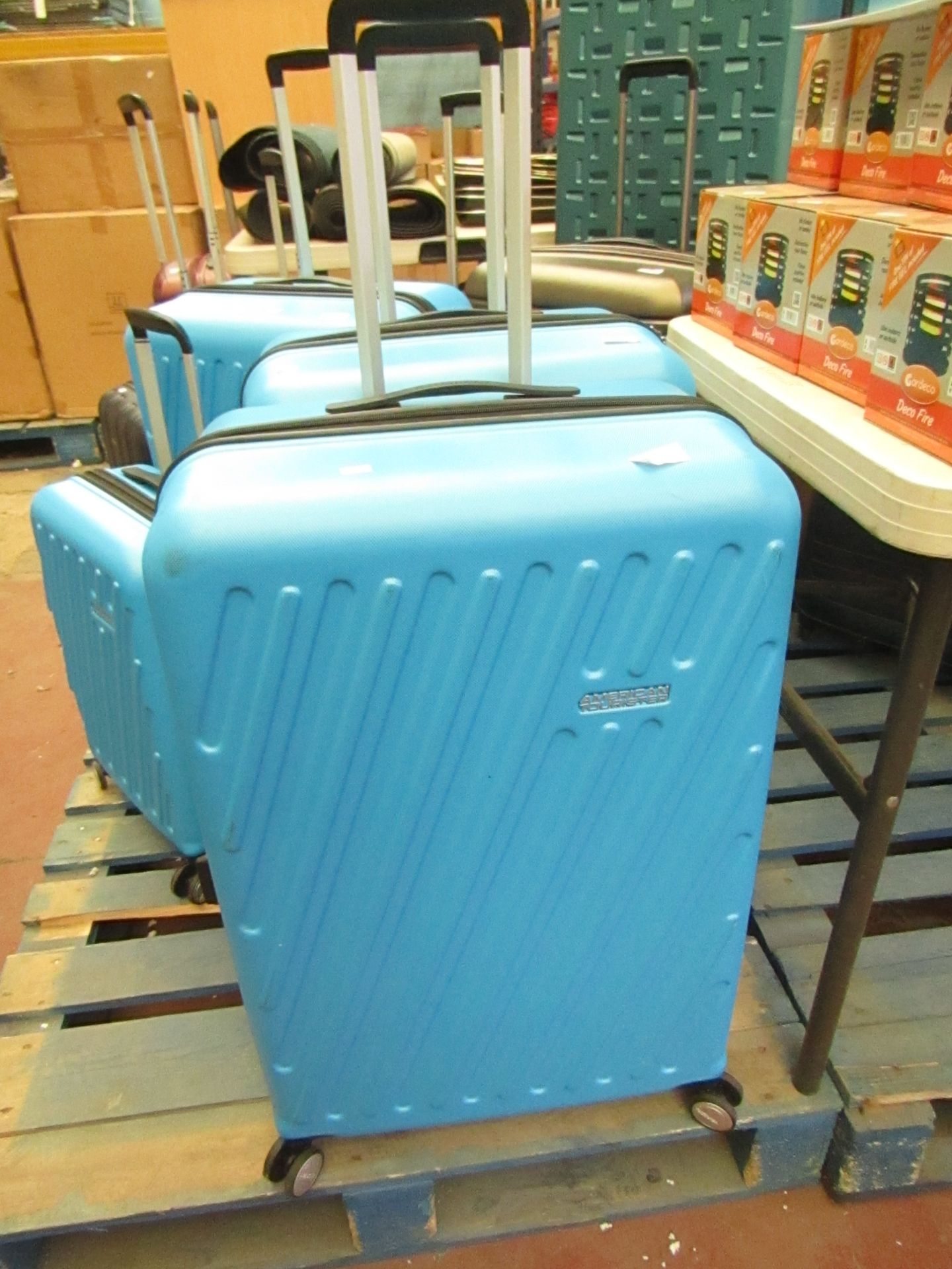 Large blue American Tourister suitcase on wheels with pull out handle,