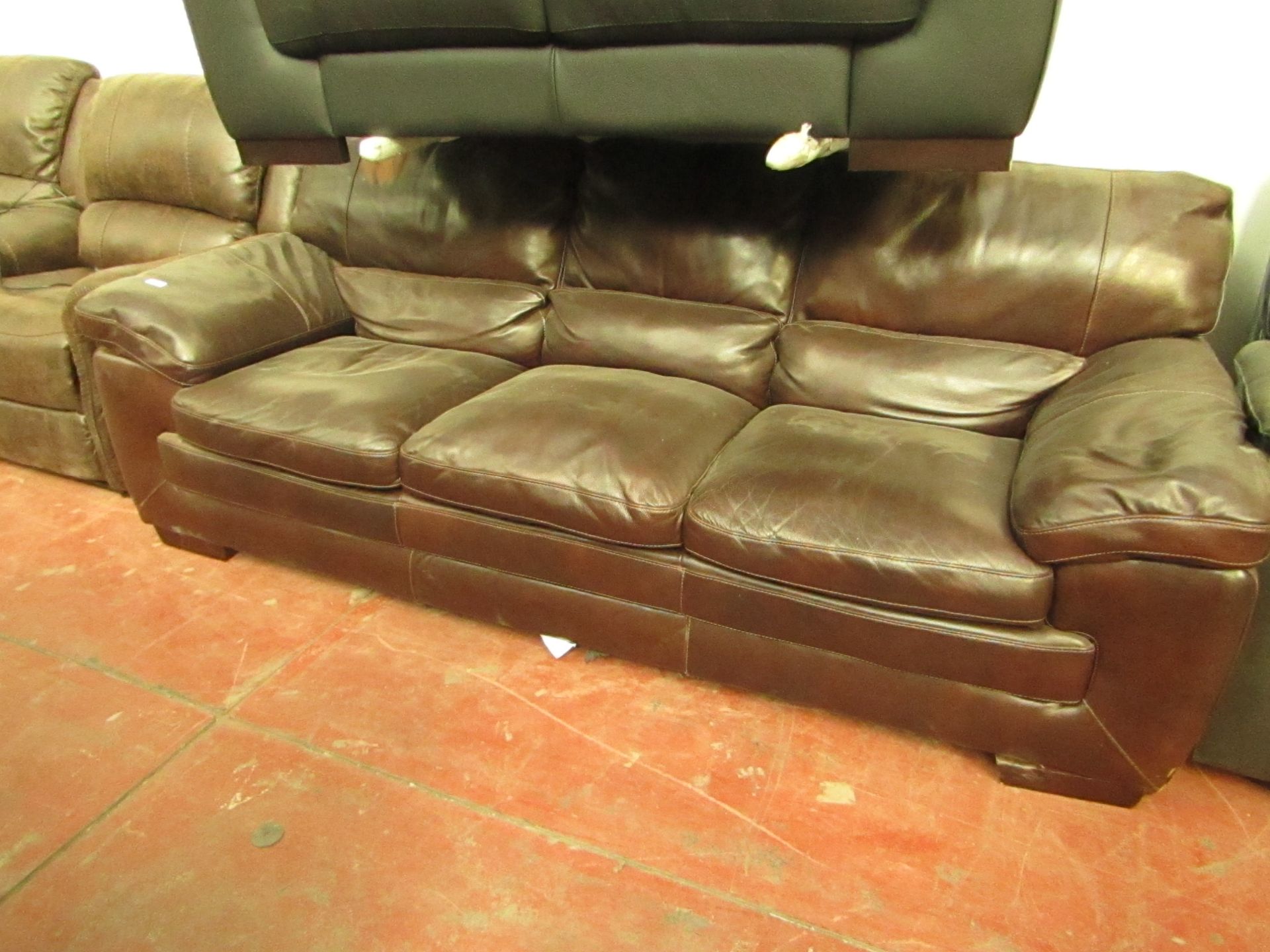 3 seater brown leather sofa with discloured patch on one head rest.