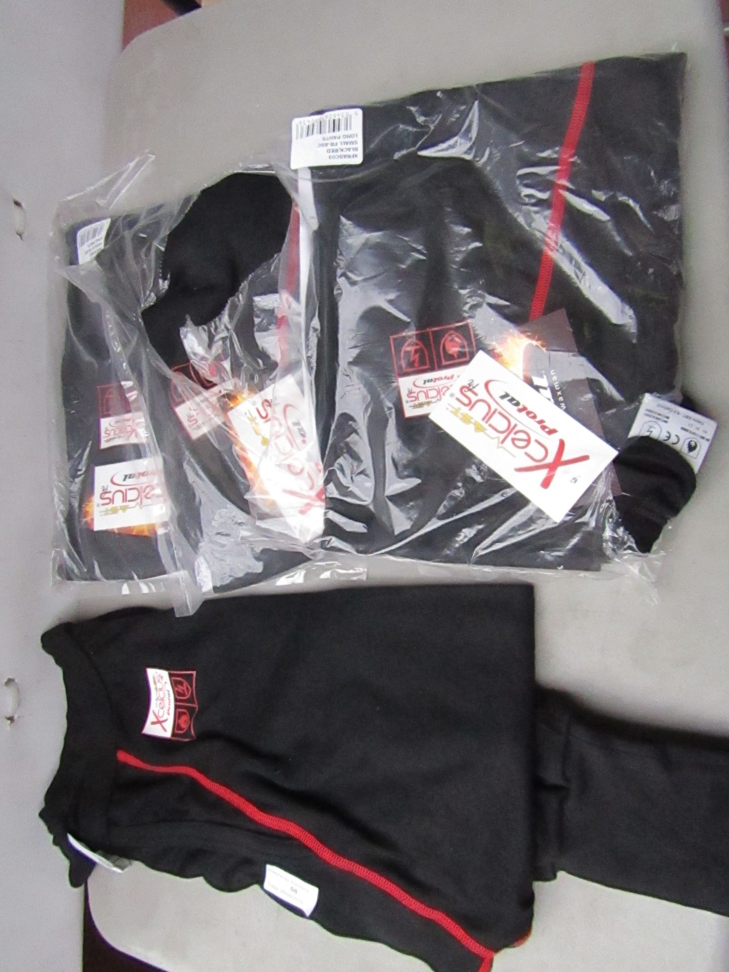 4 x items being Xcelcius Protal Flame Retardant Long Pants new, size 2 x M and 2 x S