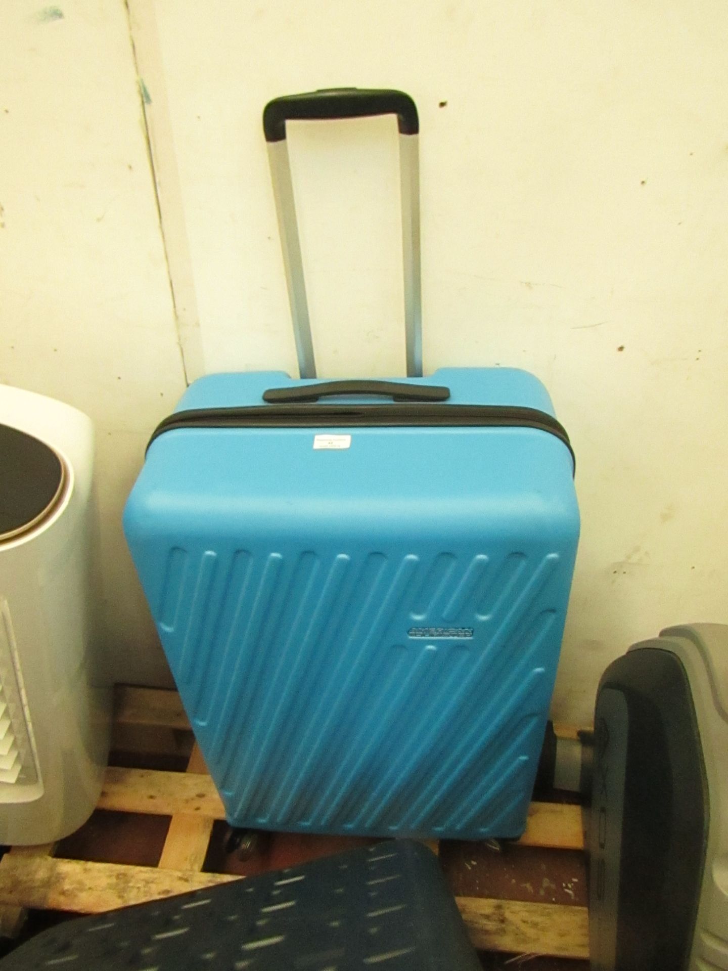 Large Blue American Tourister 4 wheel suit case, no major damage.