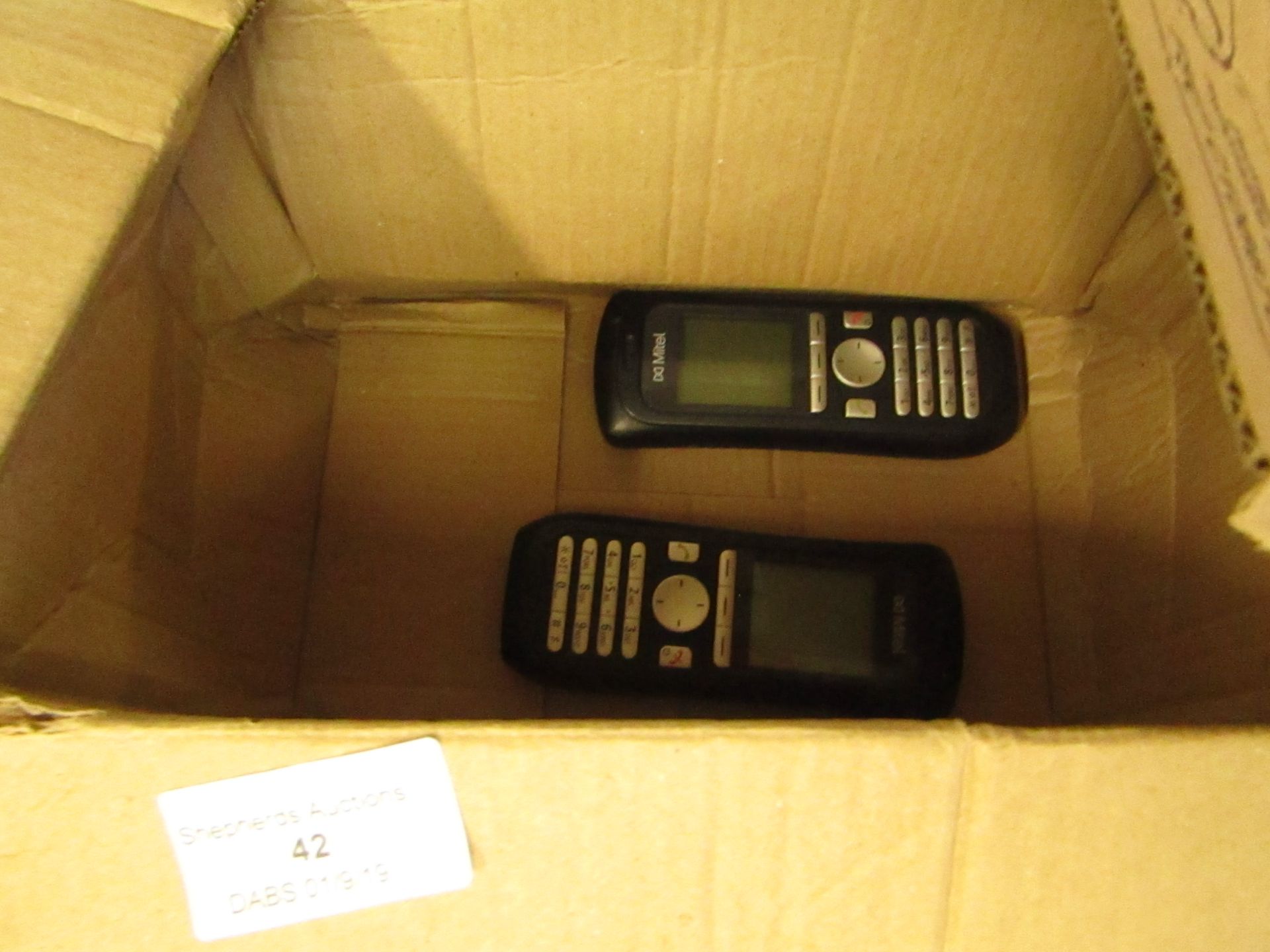 2x Mitel handsets, 1x powered on and other is untested.