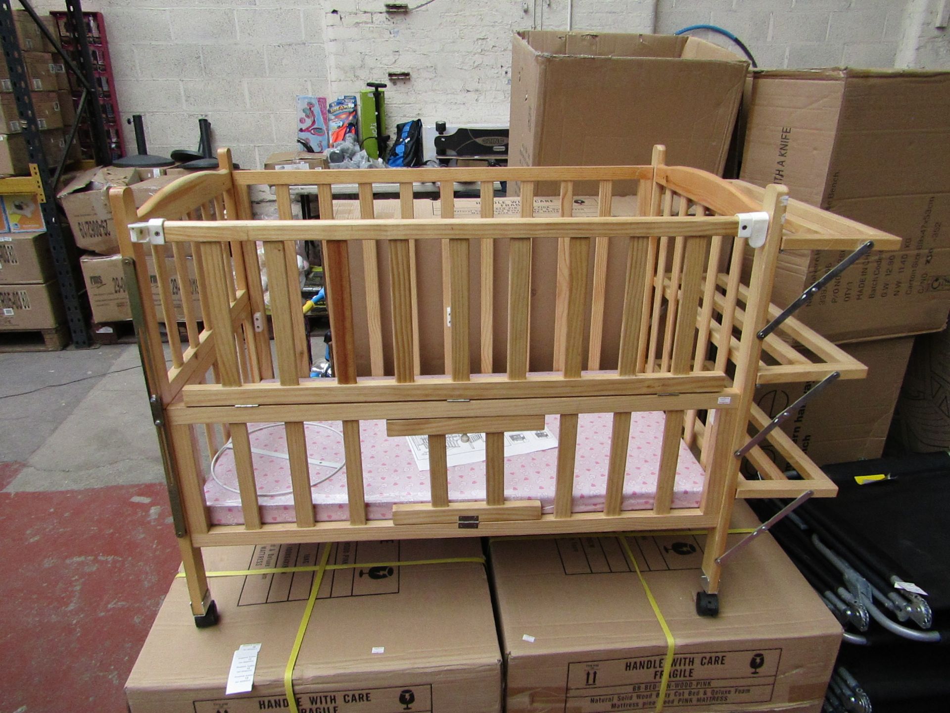 Childs wooden cot with built on shelving and Blue Mattress, new and boxed