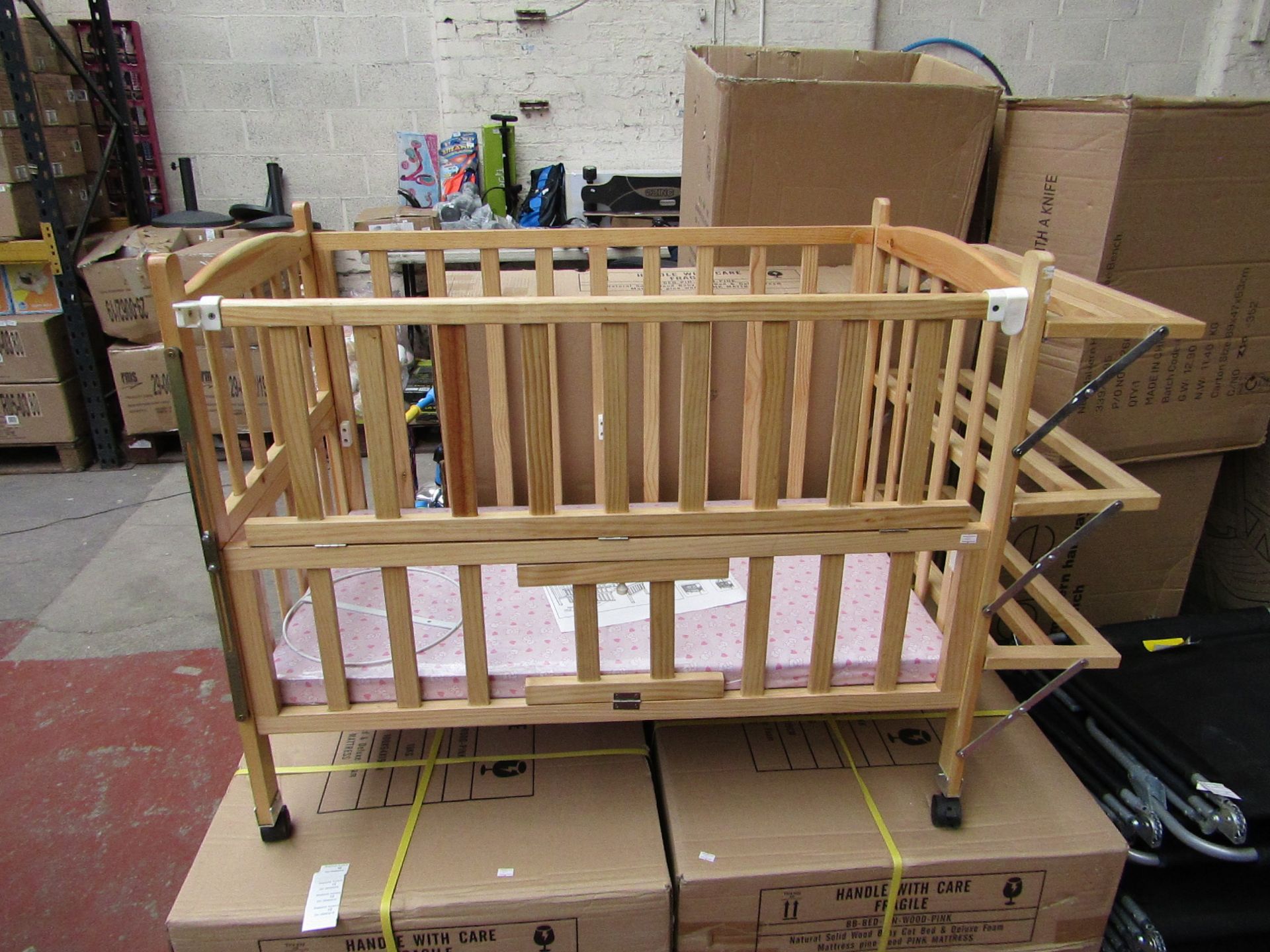 Childs wooden cot with built on shelving and Blue Mattress, new and boxed