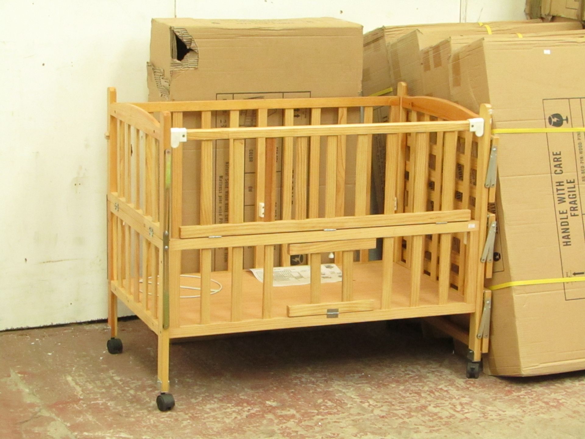 Childs cott with side shelves and Blue mattress, new and boxed.