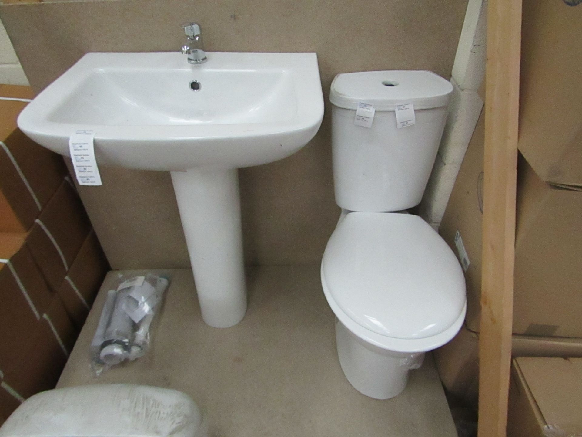 Unbranded Roca Cloakroom set that includes close coupled toilet with pan cistern, seat, flush kit, a