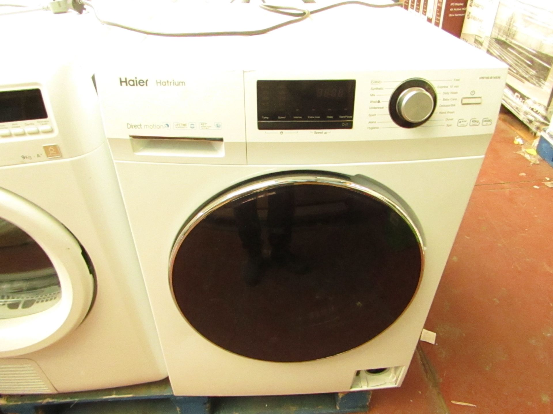 Haier Hatrium 10Kg washing machine, powers on and spins.Bottom Front Panel Is Missing