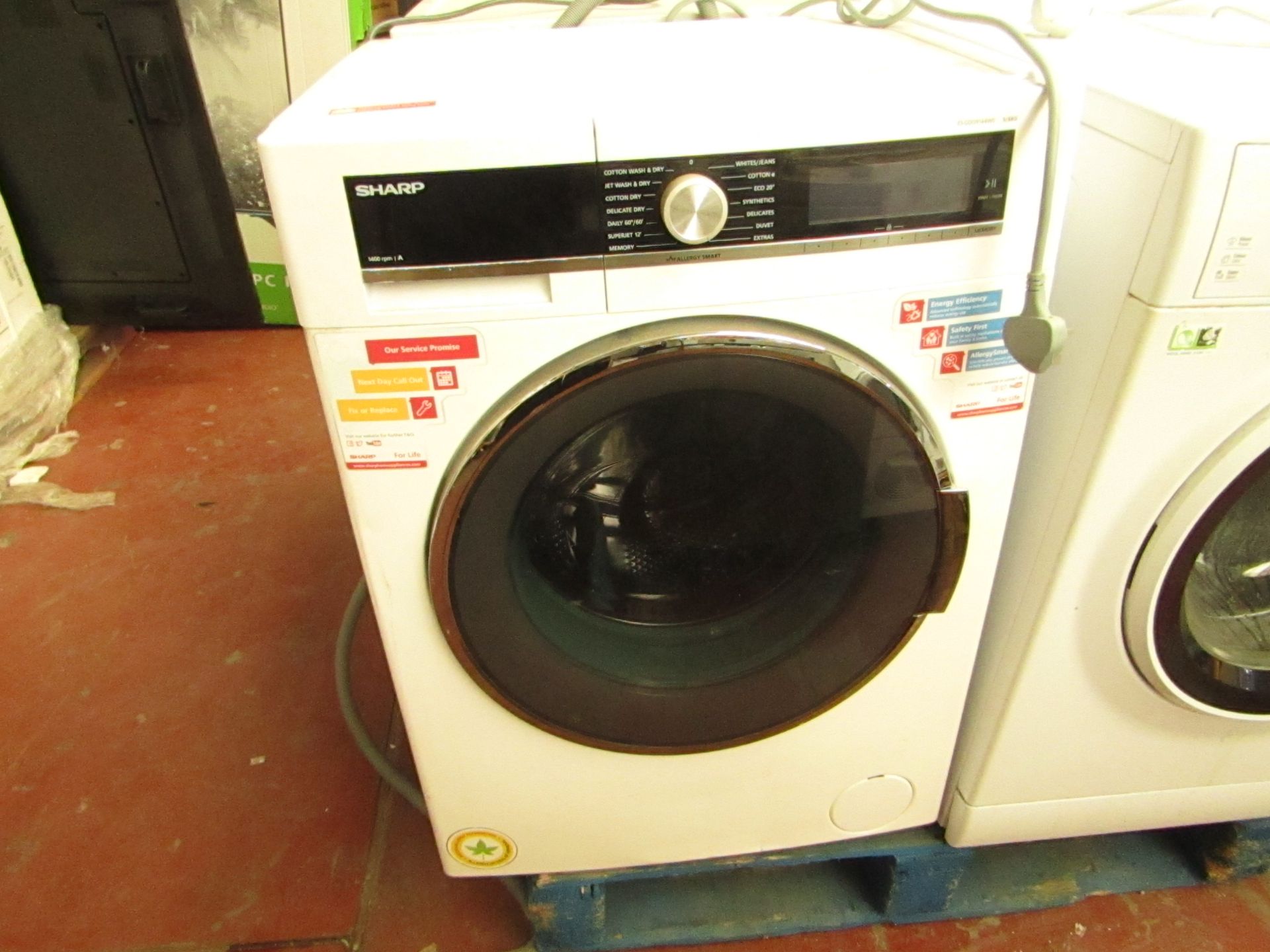 Sharp washer / dryer, 9/6Kg, powers on and no spin and door will not open so the heat is untested.