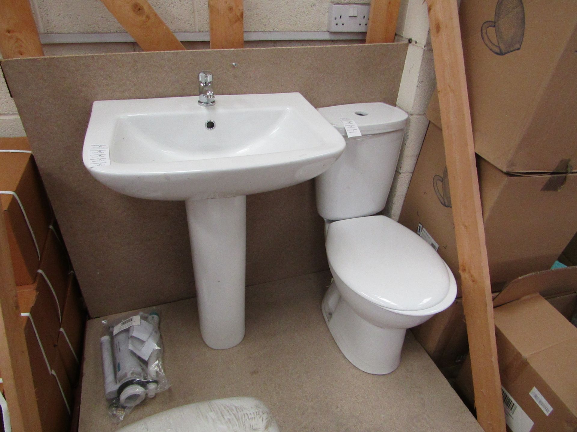 Unbranded Roca Cloakroom set that includes close coupled toilet with pan cistern, seat, flush kit, a