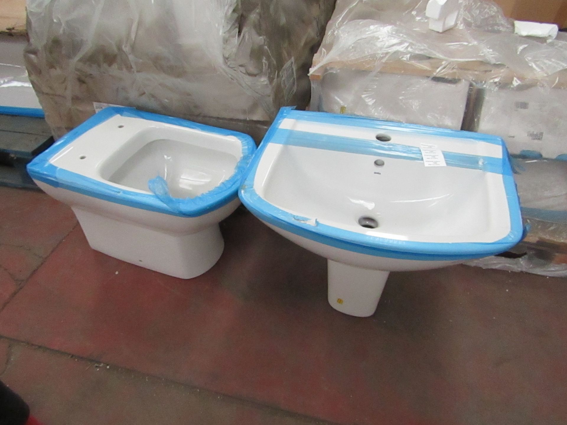 Gala Smart Bathroom set that includes a floor mounted back to wall toilet, a wall mounted sink