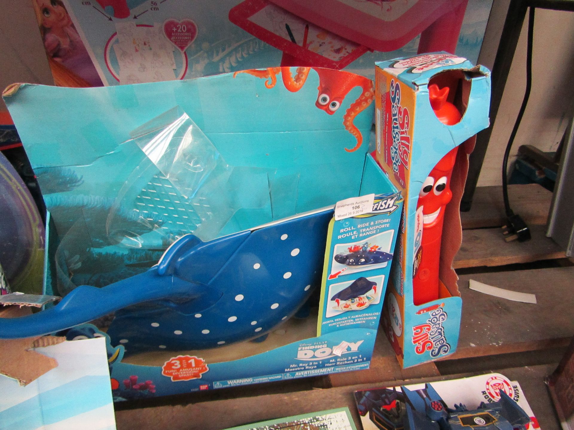 2x Children's toys being; Finding Dory sting ray with a Silly Sausage game, both packaged.