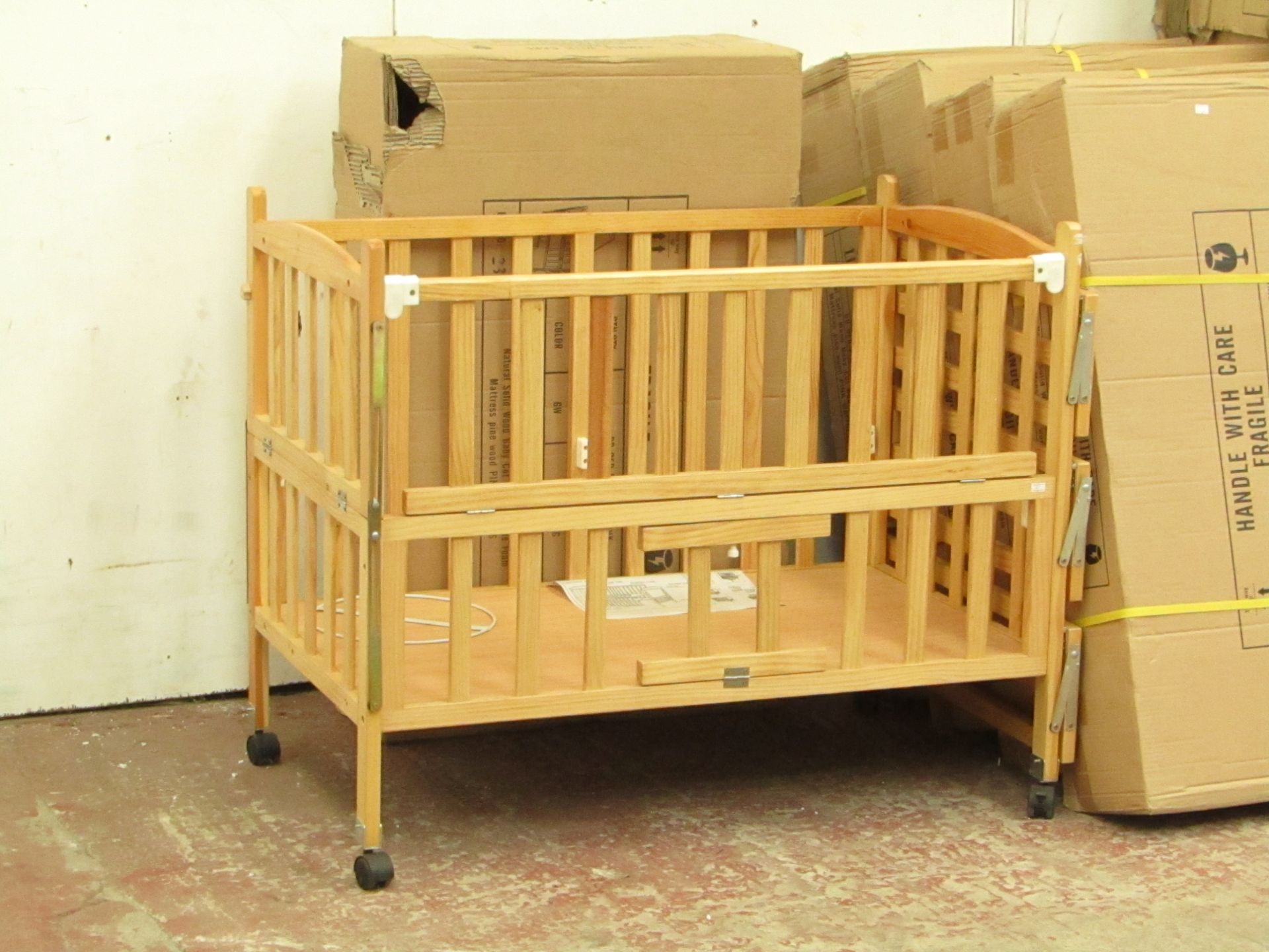 Childs cott with side shelves and Blue mattress, new and boxed.