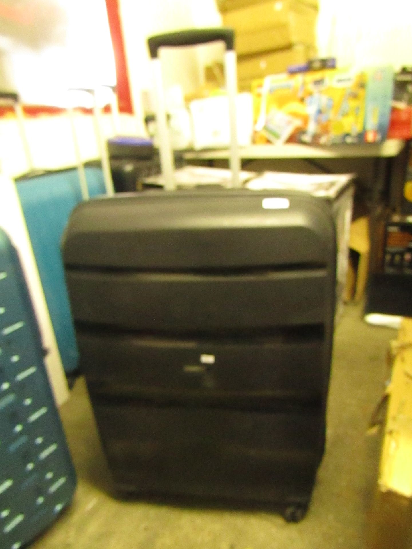 American Tourister large suitcase, no major damage.