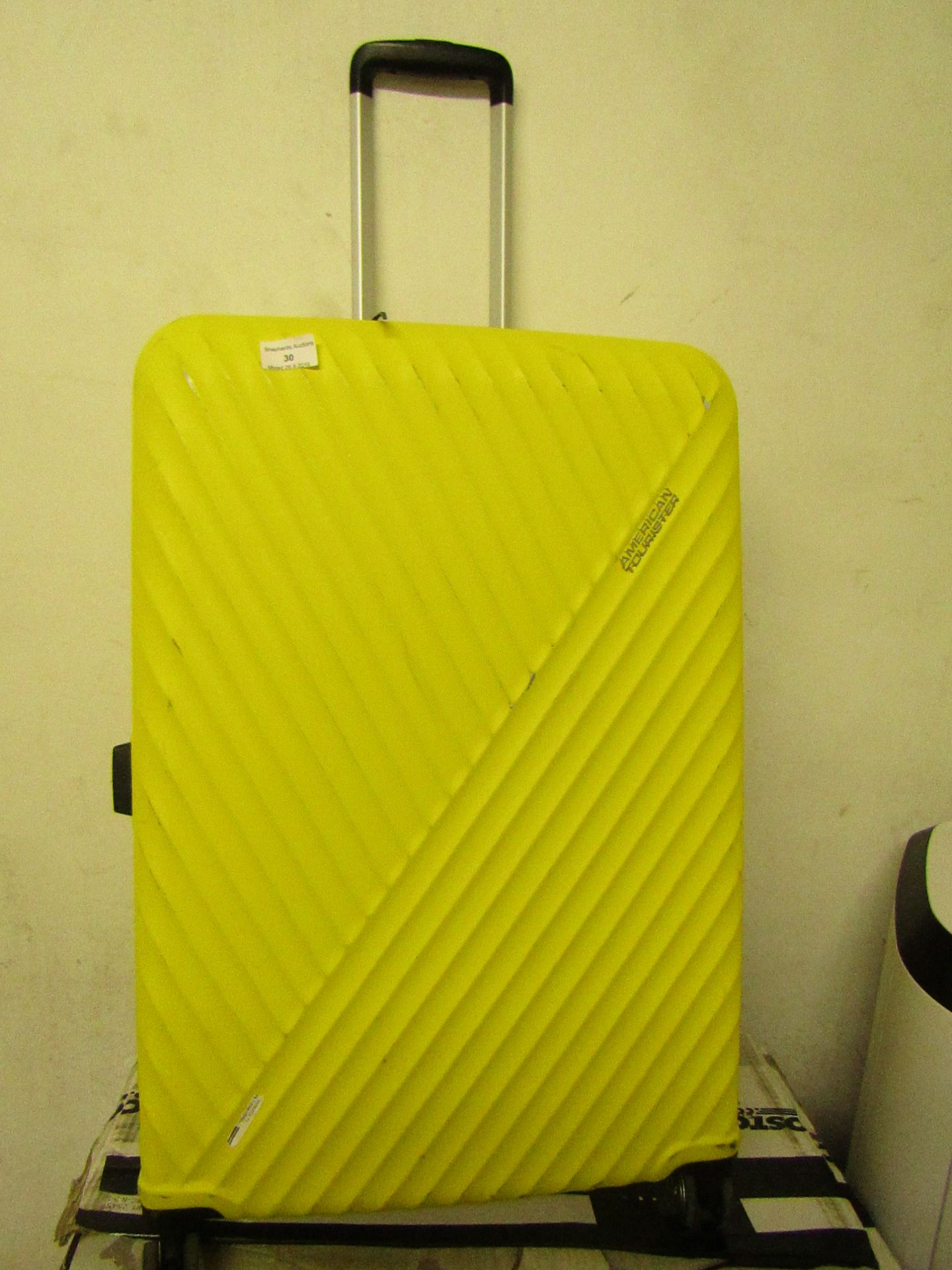 American Tourister large suitcase, wheel has fallen off.